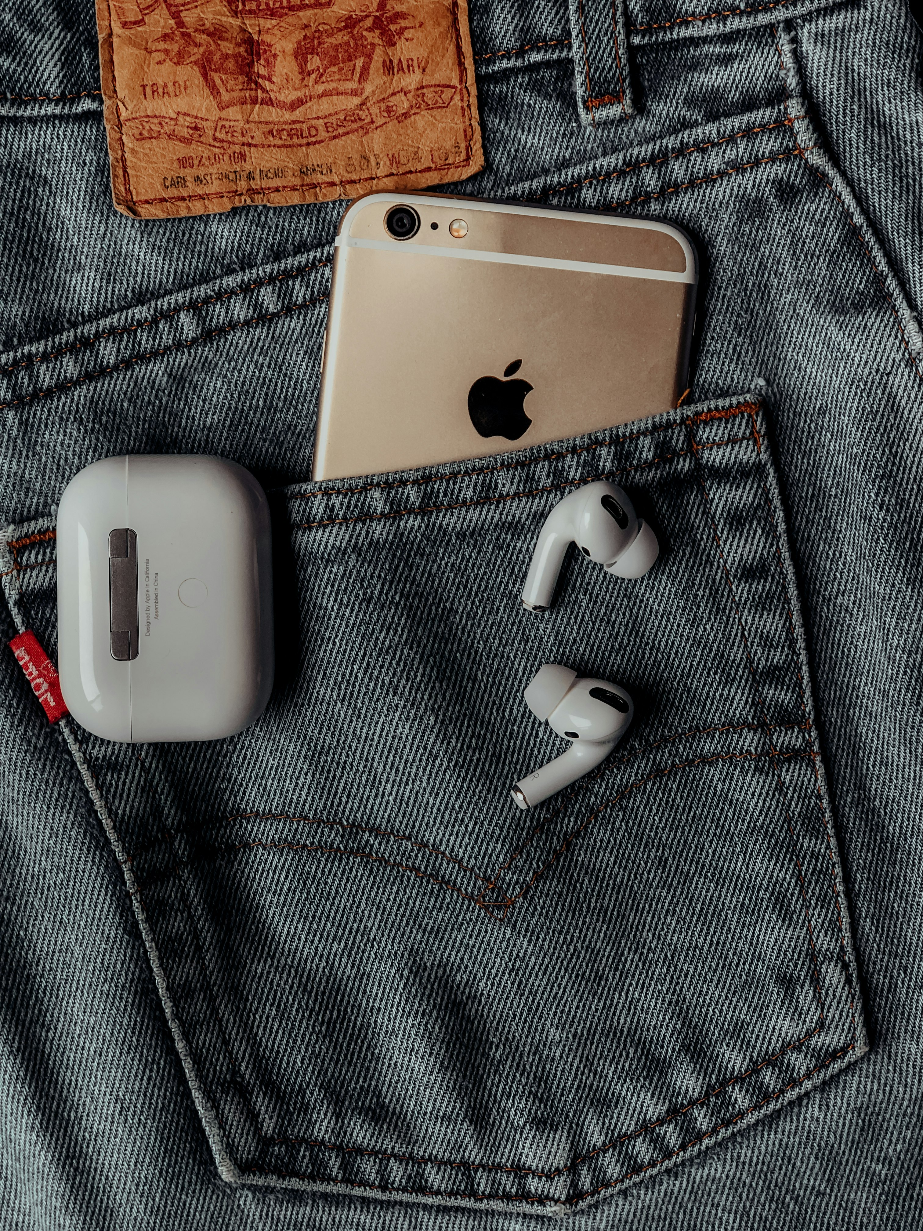 white apple airpods on silver iphone 6